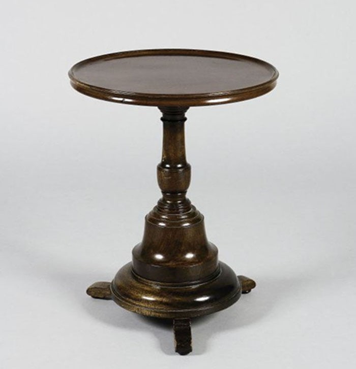 Mahogany Wine Table: Circular wooden side table featuring a round top with a slightly raised outer rim. The single central pedestal is turned and rests on a wide, tiered base. It is supported by four small, simple feet at