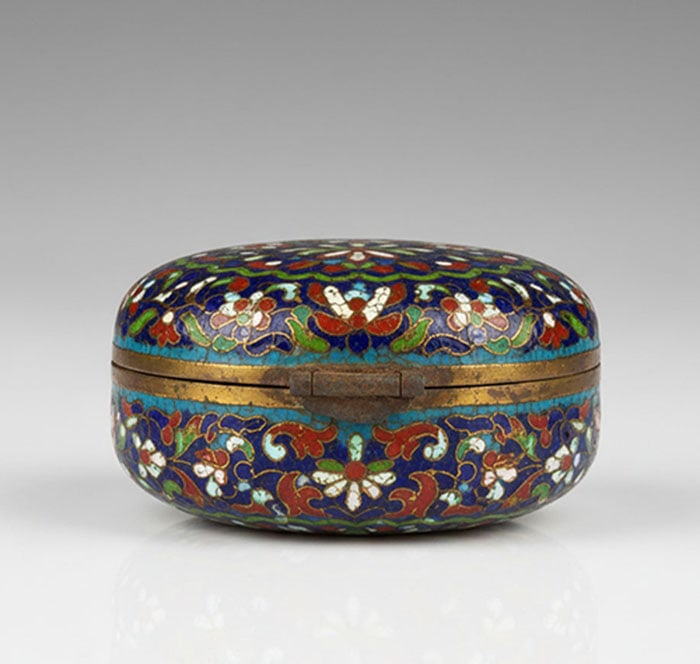Fine Cloisonne Enamel Box: Brass box with a hinged lid featuring multi-colored enamel floral patterns. Red, blue, green, and white motifs are arranged in circular bands across the surface. Metal edges show some discoloration