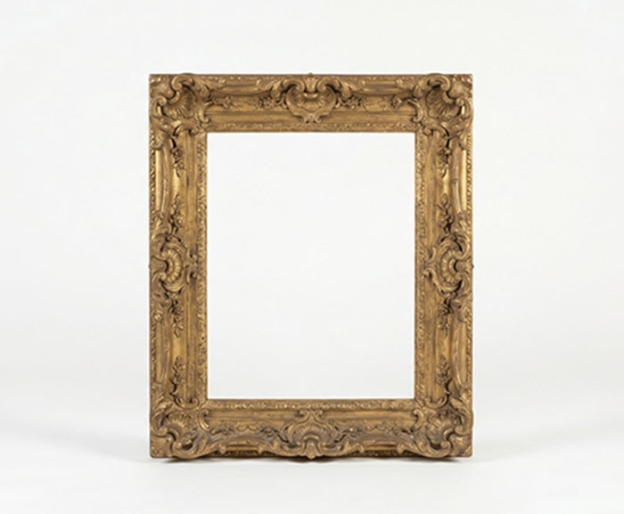 Gilt Frame: Brass frame featuring elaborate floral and scroll carvings along the edges and at each corner.
