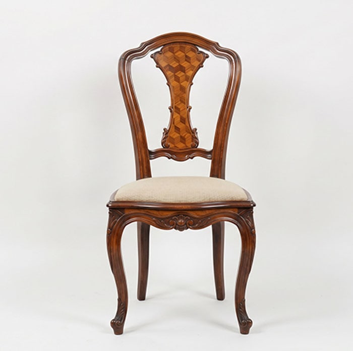 Fine Rosewood Chair: Wooden chair with a curved backrest and a central splat featuring a geometric wood inlay pattern. The seat consists of a padded cushion upholstered in a light-colored fabric. Carved wooden legs