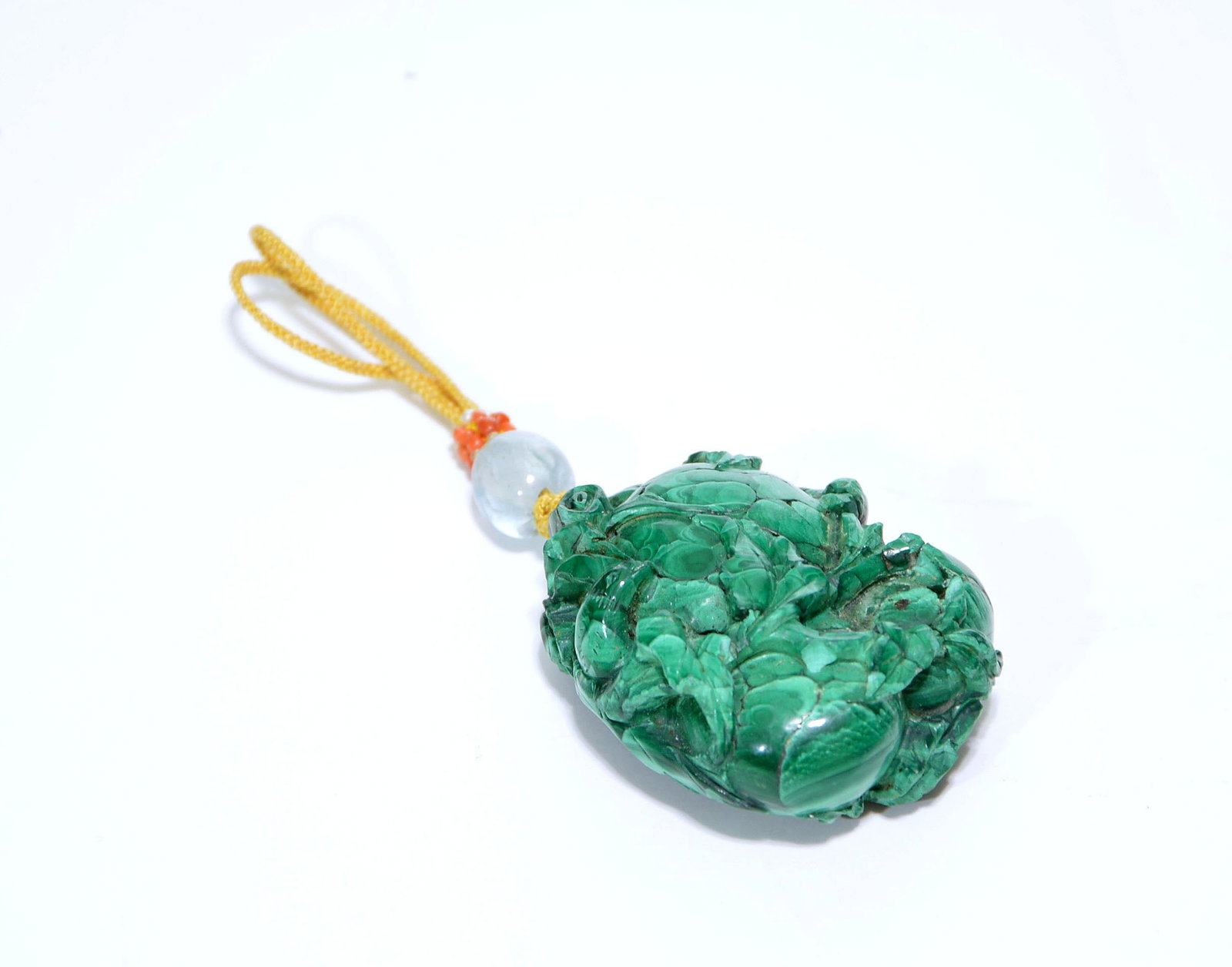 Chinese Carved 'Fruit' Malachite Pendant: Malachite toggle or pendant meticulously carved in high relief to represent a lush floral and foliate composition, highlighting the stone's vivid concentric banding and rich verdant saturations. The o