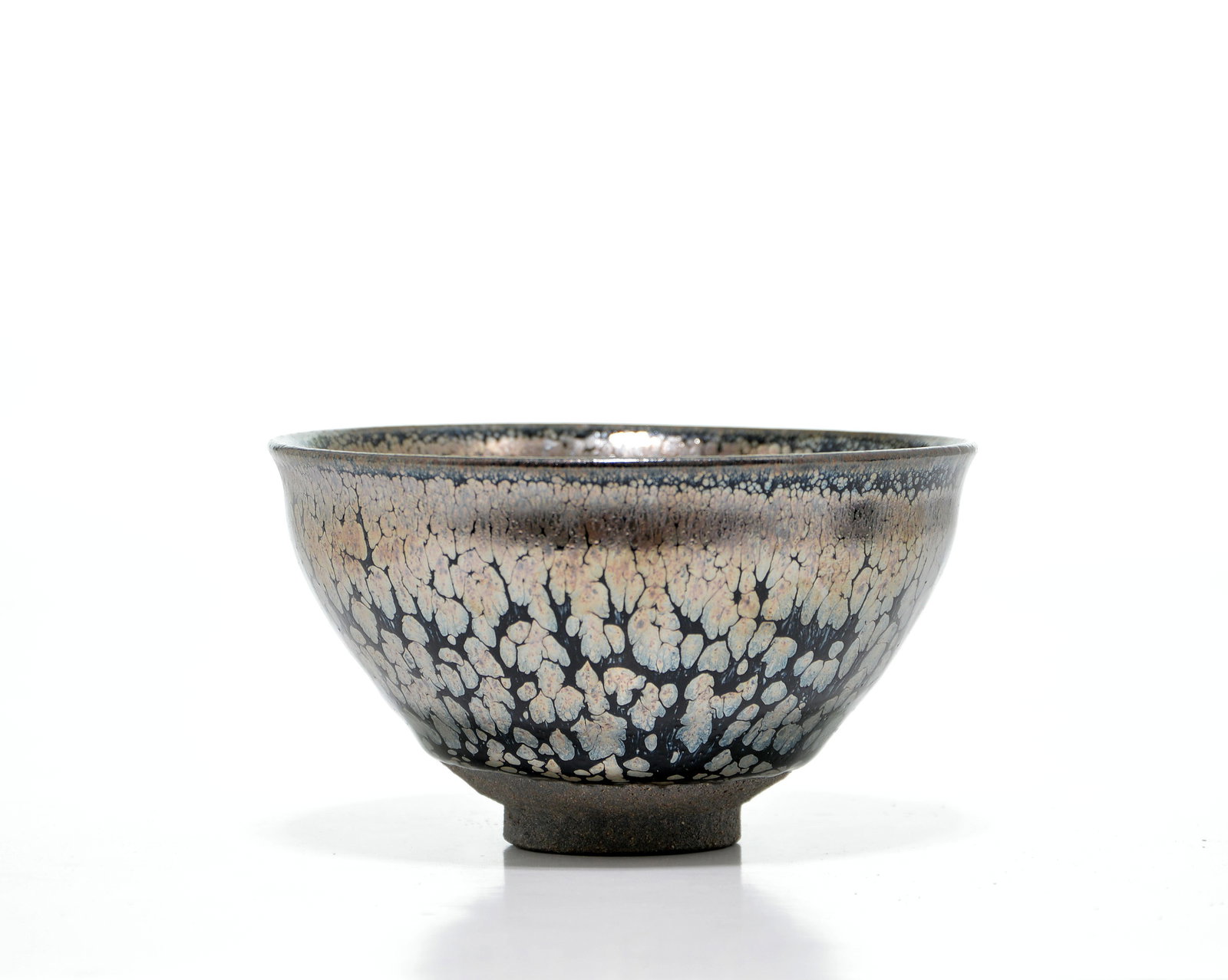 Rare Chinese 'Temmoku' Bowl: Bowl of refined conical form, meticulously potted with deep sides that rise from a small, circular foot to a flared rim. The vessel is covered in a lustrous, dark glaze that is densely suffused with