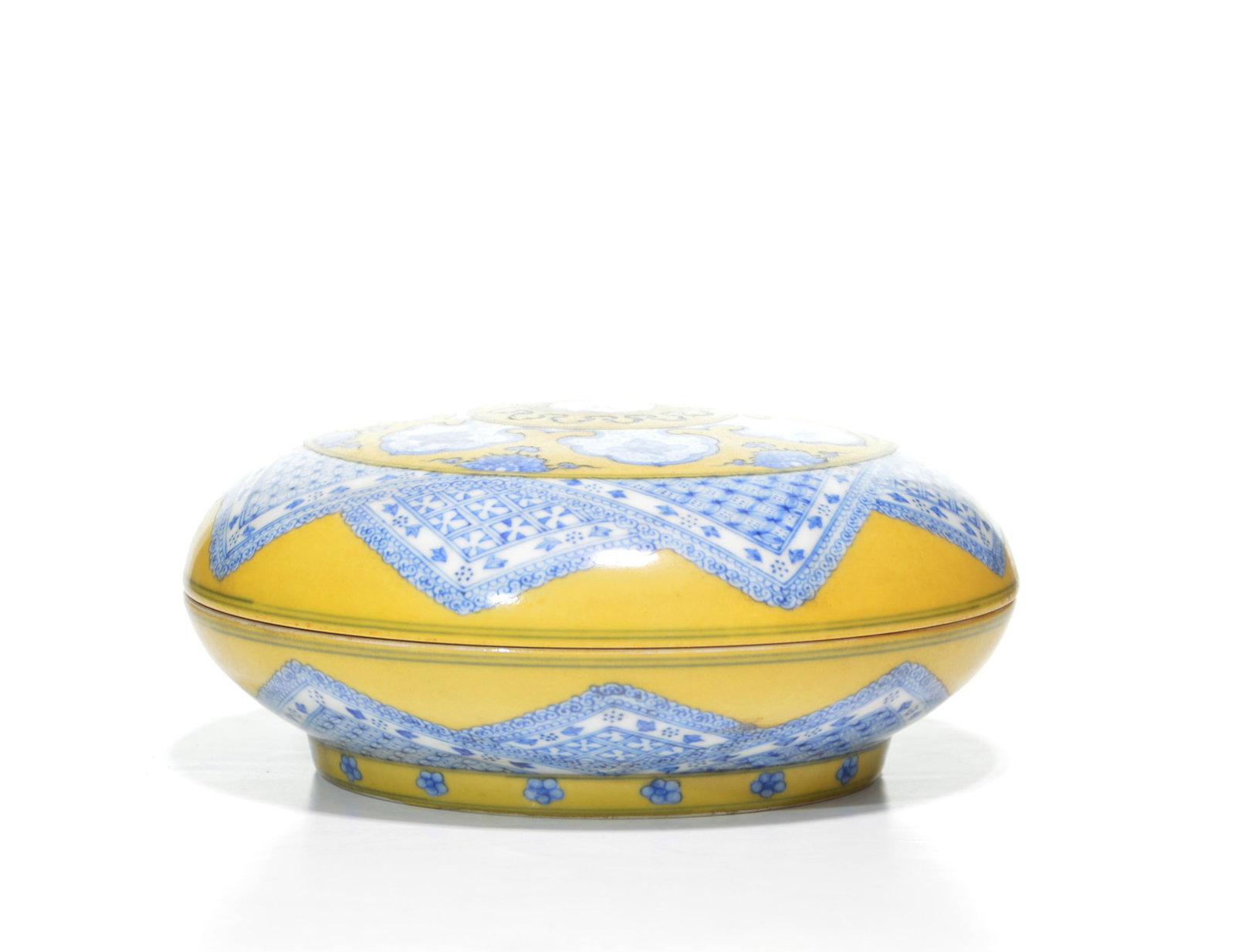 Chinese Yellow-Enamel Porcelain Box: Circular porcelain box and cover of compressed globular form, meticulously decorated with underglaze blue motifs against a vibrant yellow ground. The cover is centered by a complex geometric medallion