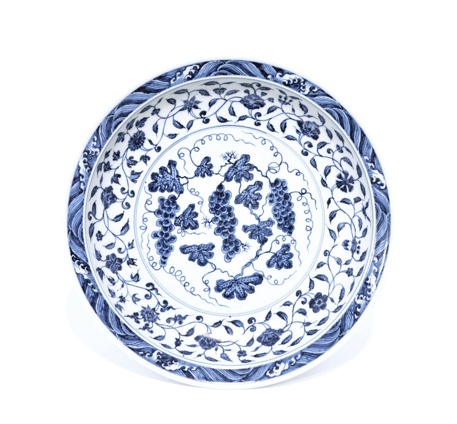 Extremely Fine Chinese Yongle-Style 'Grapevine' Dish: Dish of circular form, masterfully painted in vibrant cobalt blue with a central medallion featuring succulent grape clusters and scrolling tendrils within a triple-line border. The deep cavetto is el