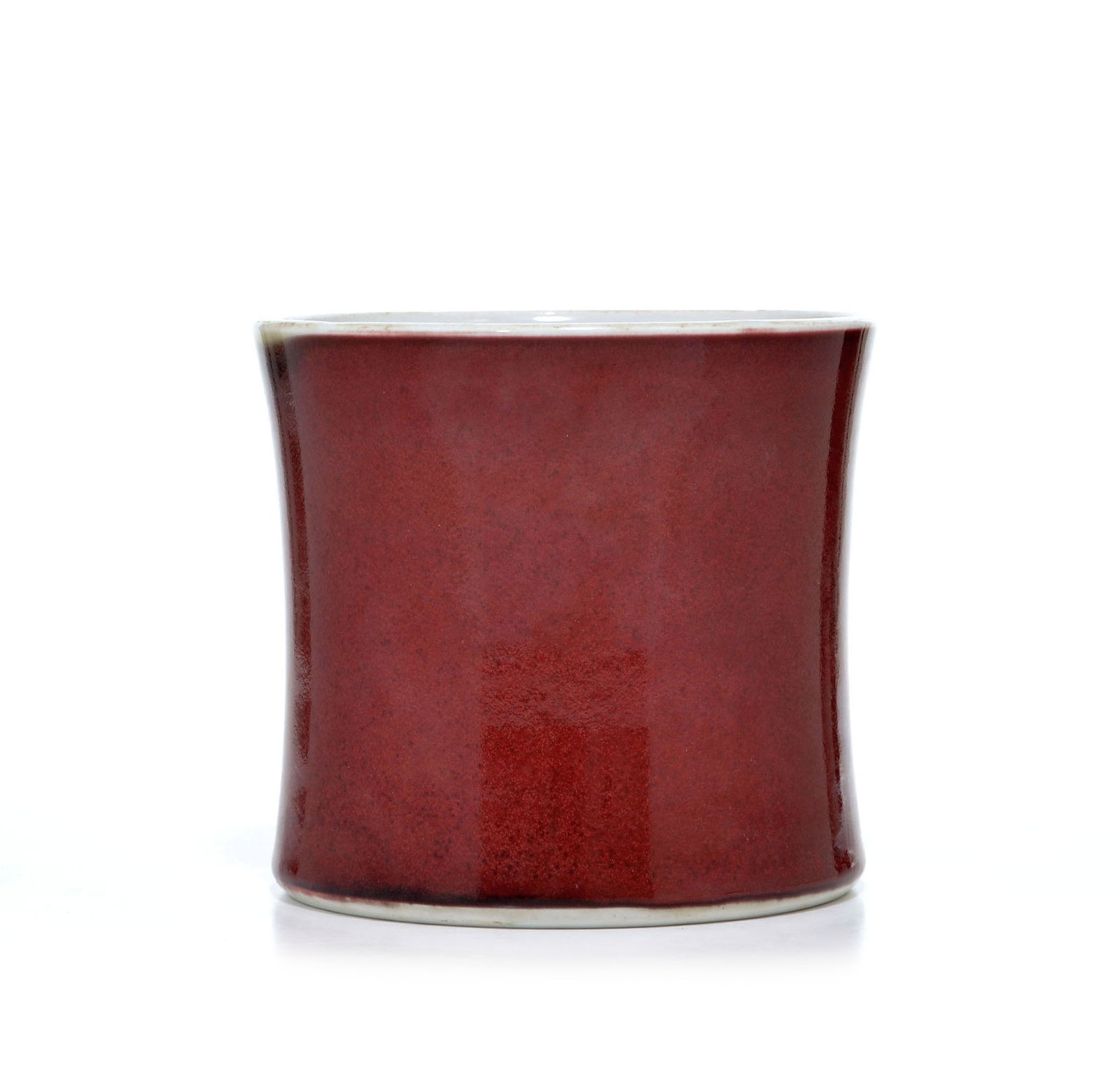 Chinese Langyao-Red Brush Pot: Brush pot of elegant cylindrical form with slightly waisted sides, meticulously applied with a rich copper-red glaze of deep ox-blood hue. The vibrant monochrome glaze is characterized by subtle tonal