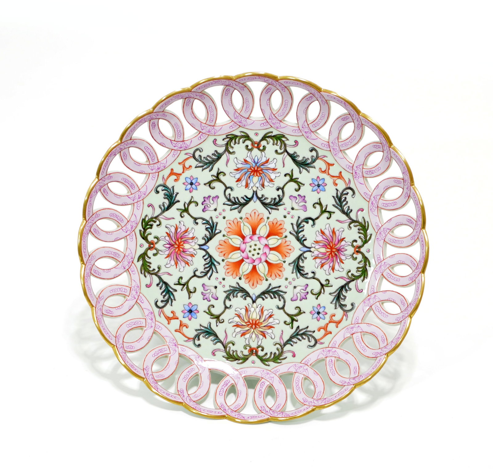 Chinese Famille Rose Floral Plate: Reticulated porcelain plate of circular form featuring an elegantly pierced border of interlocking rings decorated with delicate pink scrolling motifs. The central medallion is richly enameled with a