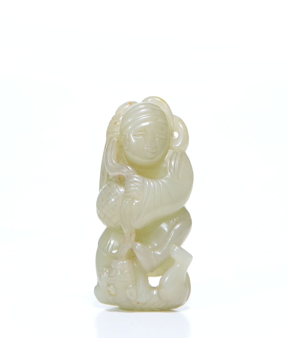 Chinese Carved Jade Figure: Jade carving skillfully worked from a pale, translucent stone to depict a male figure in a spirited posture. The artisan has captured the subject's animated expression and flowing garments with refine