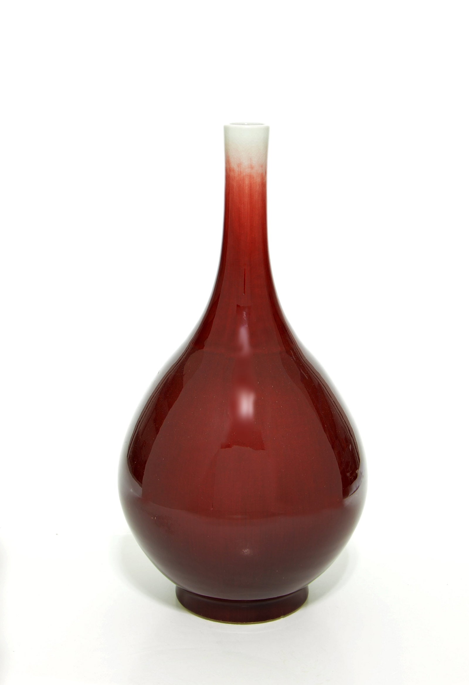 Large Chinese Langyao-Red Porcelain Vase: Vase of elegant pear-shaped form, the compressed globular body tapering gracefully into a tall slender neck. The exterior is covered in a deep, vitreous oxblood glaze that pools to a dark ruby tone