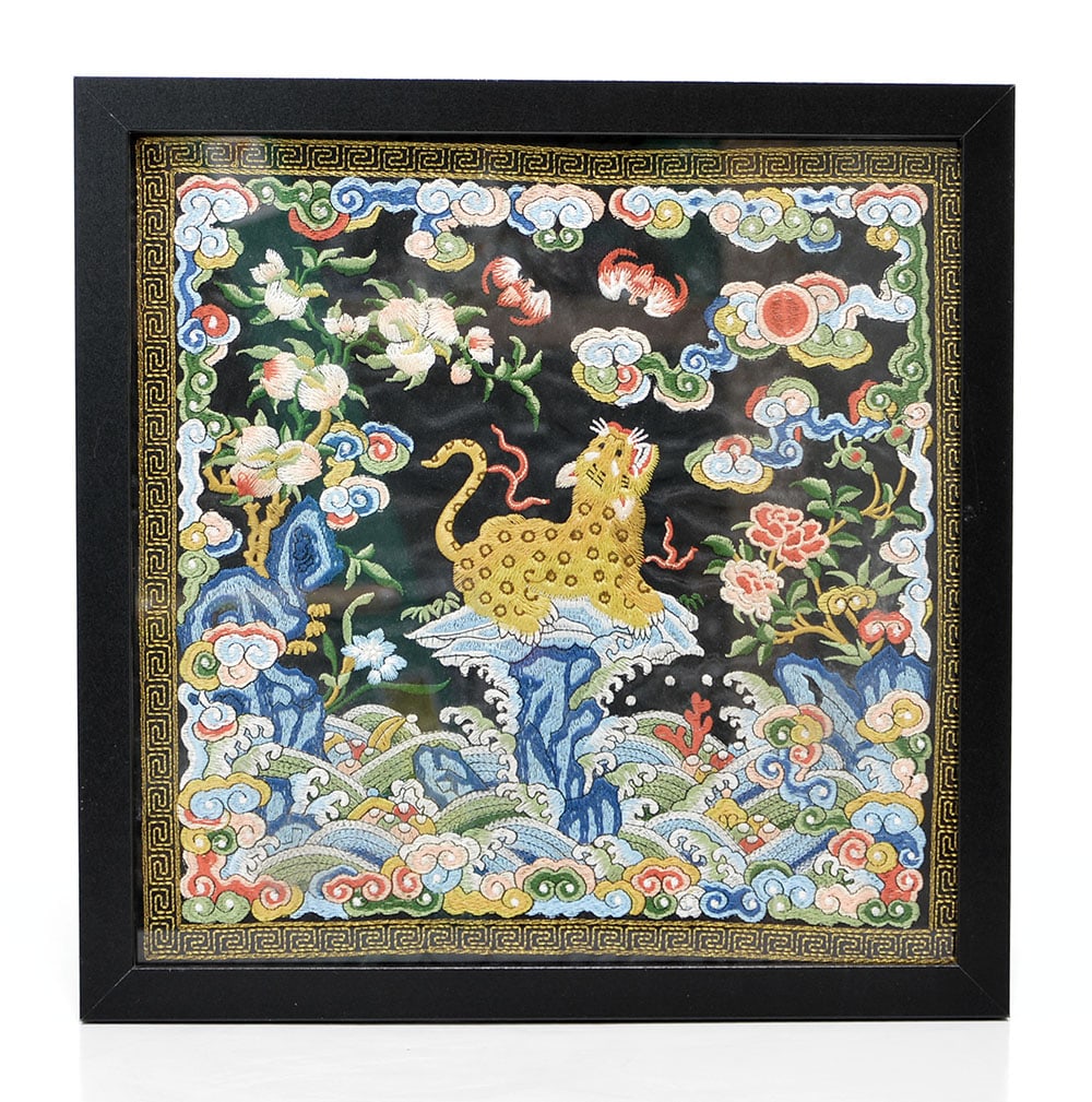 Chinese Silk Embroidered Badge: Silk rank badge meticulously embroidered with a central leopard figure perched atop a rocky outcrop amidst turbulent waves and auspicious ruyi-shaped clouds. The vibrant composition is further embelli