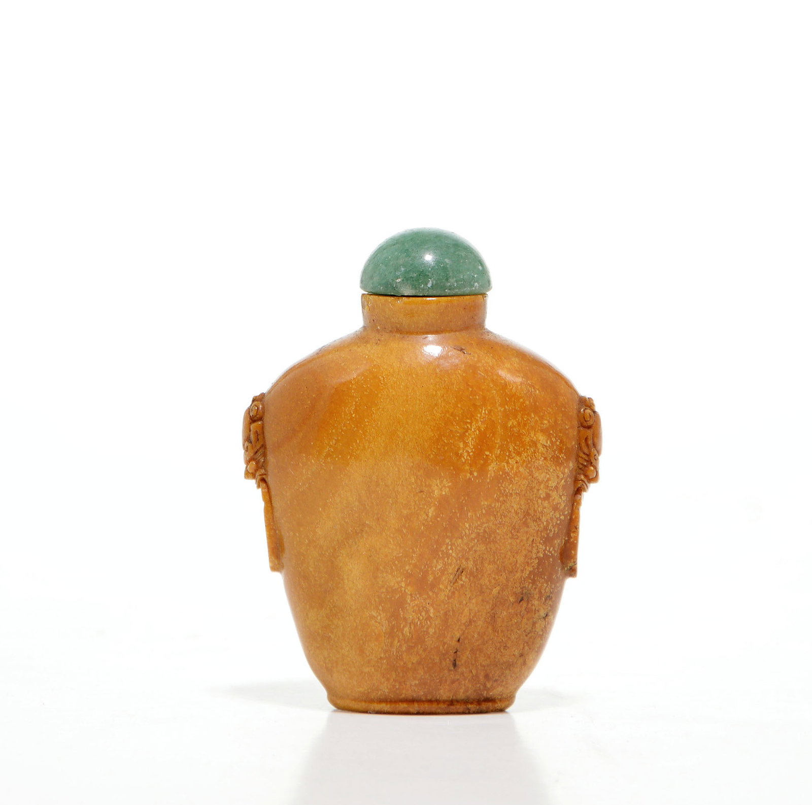 Chinese Root Amber Snuff Bottle: Carved from a warm, honey-toned translucent stone, featuring a well-rounded ovoid body. The sides are intricately decorated with high-relief beast-mask handles suspending mock rings, a classic archais