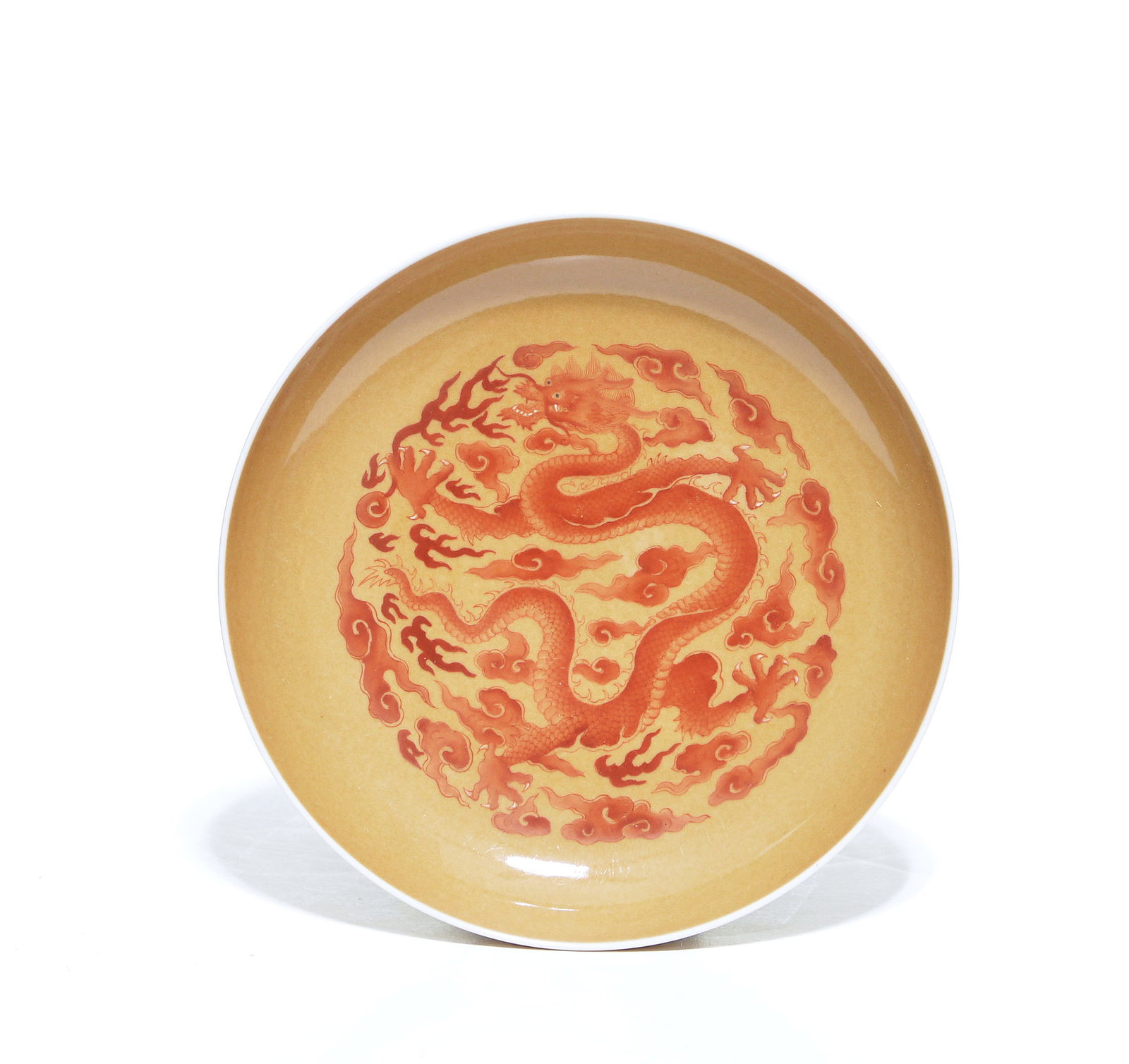 Fine Chinese Iron Red Dragon Dish: Dish of shallow rounded form, the interior masterfully rendered with a sinuous five-clawed dragon writhing amidst stylized clouds and flame scrolls, all meticulously painted in iron-red against a vibr