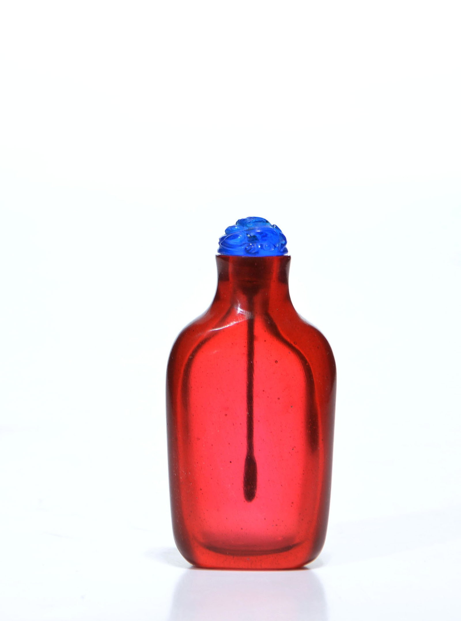 Chinese Red Glass Snuff Bottle: Snuff bottle of flattened ovoid form, fashioned from vibrant translucent ruby-red glass with slightly recessed panels to the front and back. The elegant shoulders taper gracefully into a short neck, s
