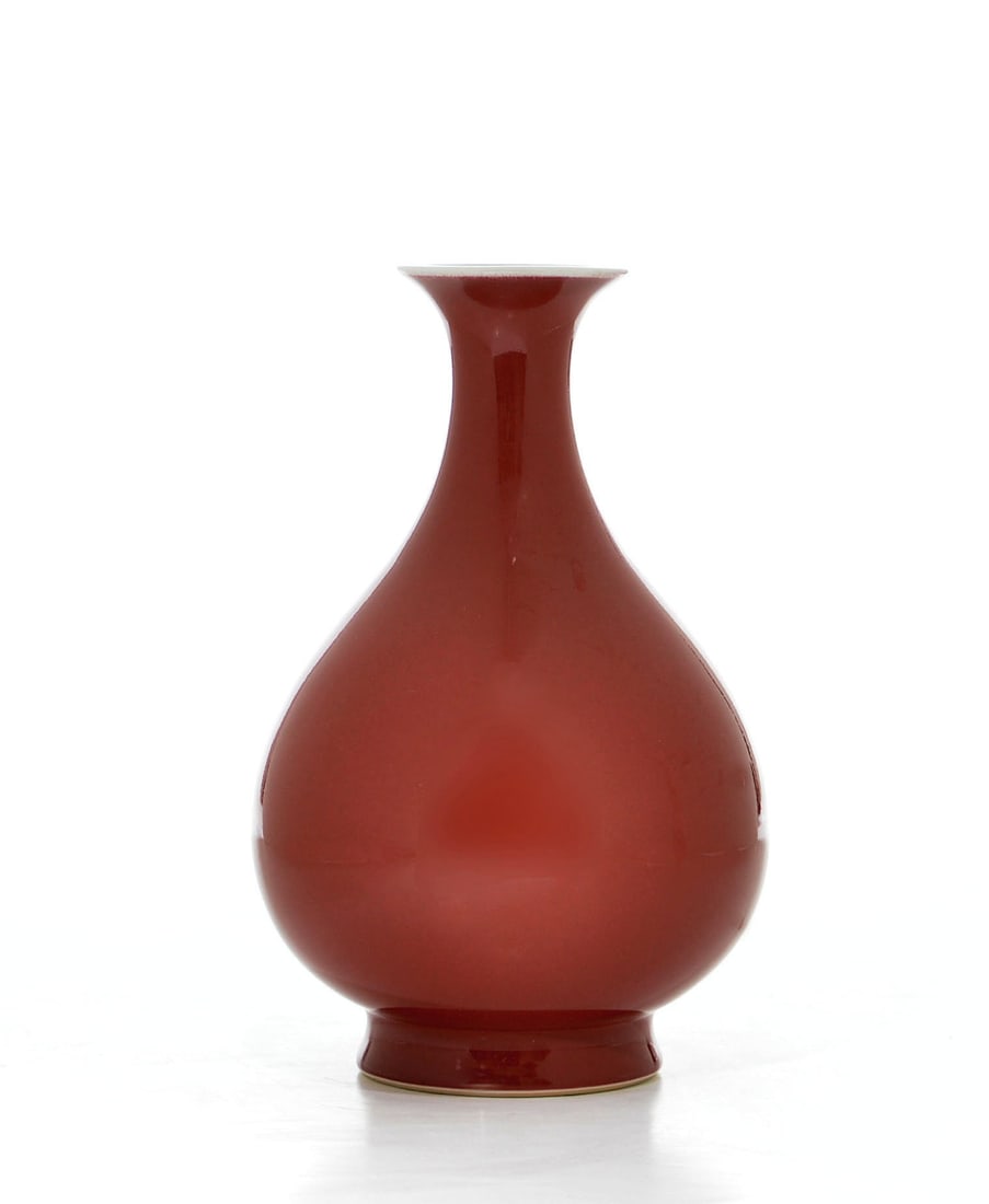 Fine Chinese Copper-Red Vase: Vase of elegant Yuhuchun form, the pear-shaped body rising from a short foot to a slender neck and subtly everted rim. The exterior is enveloped in a rich, saturated copper-red glaze of exceptionally 