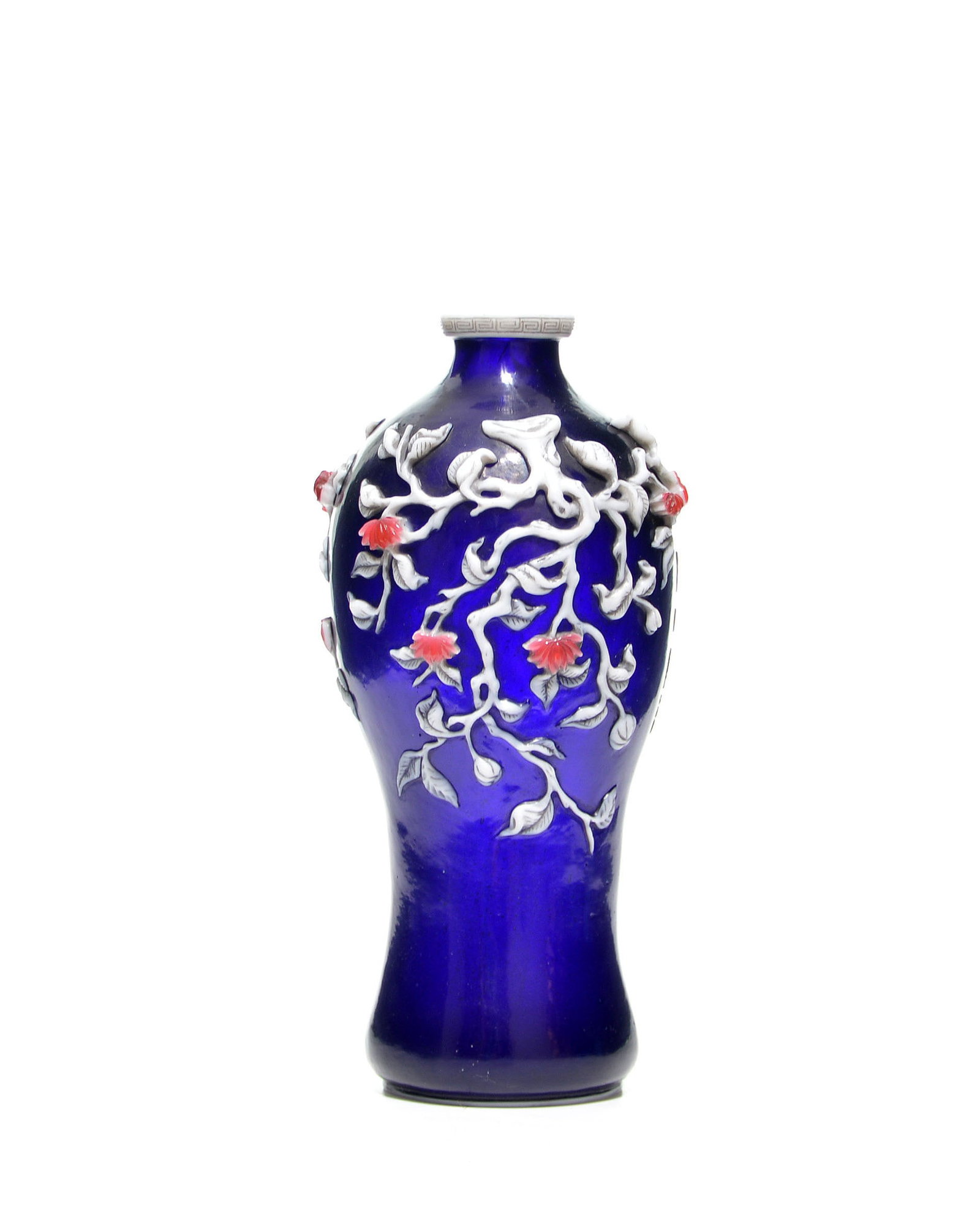 Chinese Blue Glass Overlay Vase: Vase of elegant elongated form crafted from deep cobalt blue glass, featuring a striking overlay decoration. The body is meticulously adorned with an applied floral branch in white glass with red blos