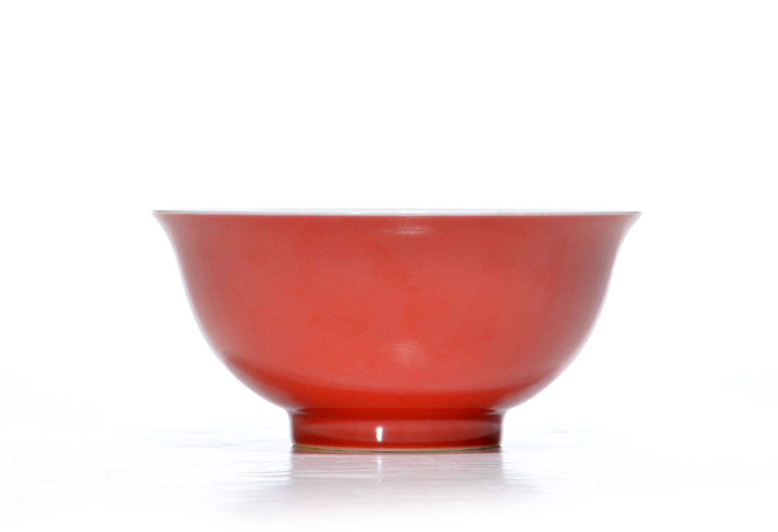 Very Fine Chinese Coral-Red Enamel Bowl: Coral-red ceramic bowl features a flared rim and a tapered footed base. Interior surface displays a multi-colored floral design with pink and orange flowers and green leaves. Yongzheng mark on base. 1