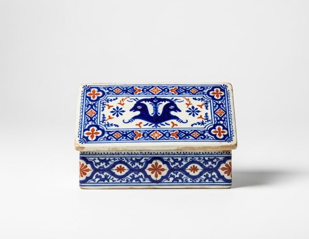 Porcelain Writing Stand: An elegant 18th-century Rouen faience rectangular writing stand, featuring sophisticated lambrequin decoration in a characteristic cobalt blue and iron red palette. This refined piece of French