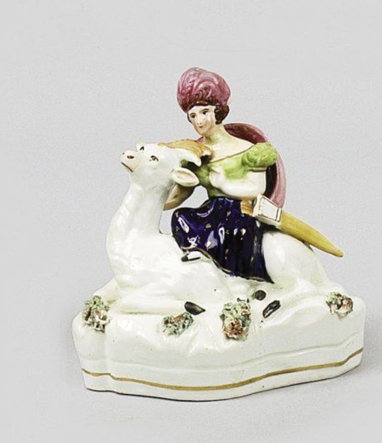 Porcelain Figures: Pair of polychrome fine earthenware groups depicting a couple of Middle Eastern figures seated on camels.