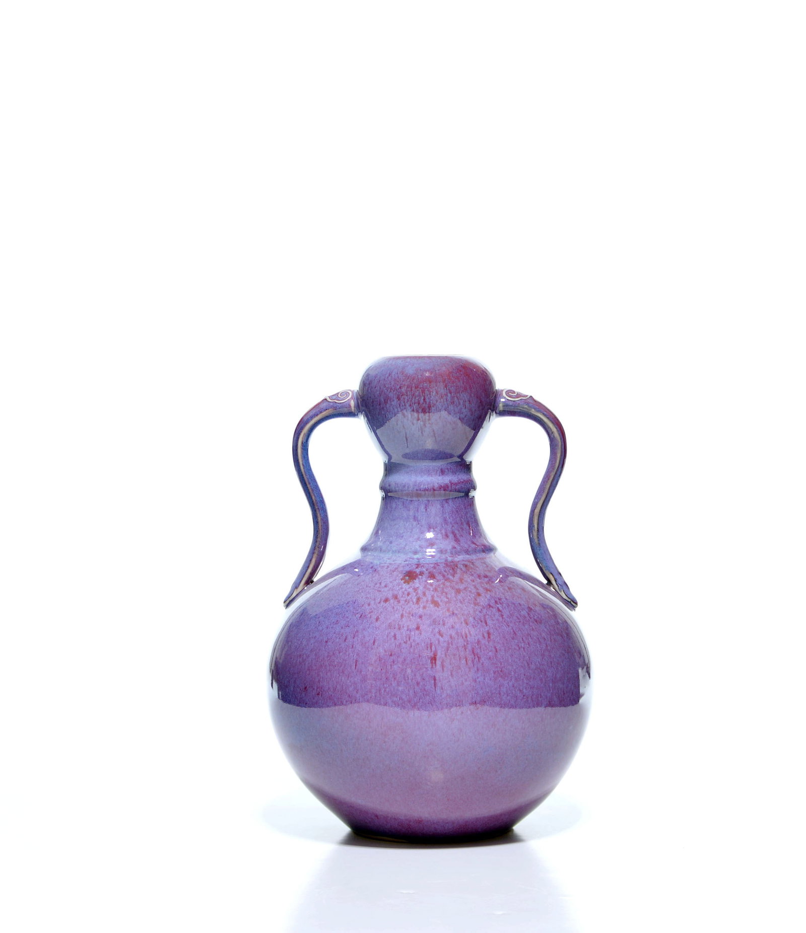 Fine Chinese Flambe-Glaze Gourd Vase: The compressed globular body rises to a waisted neck and rounded mouth, flanked by a pair of slender loop handles with scroll terminals. It is covered overall in a variegated lavender-purple and