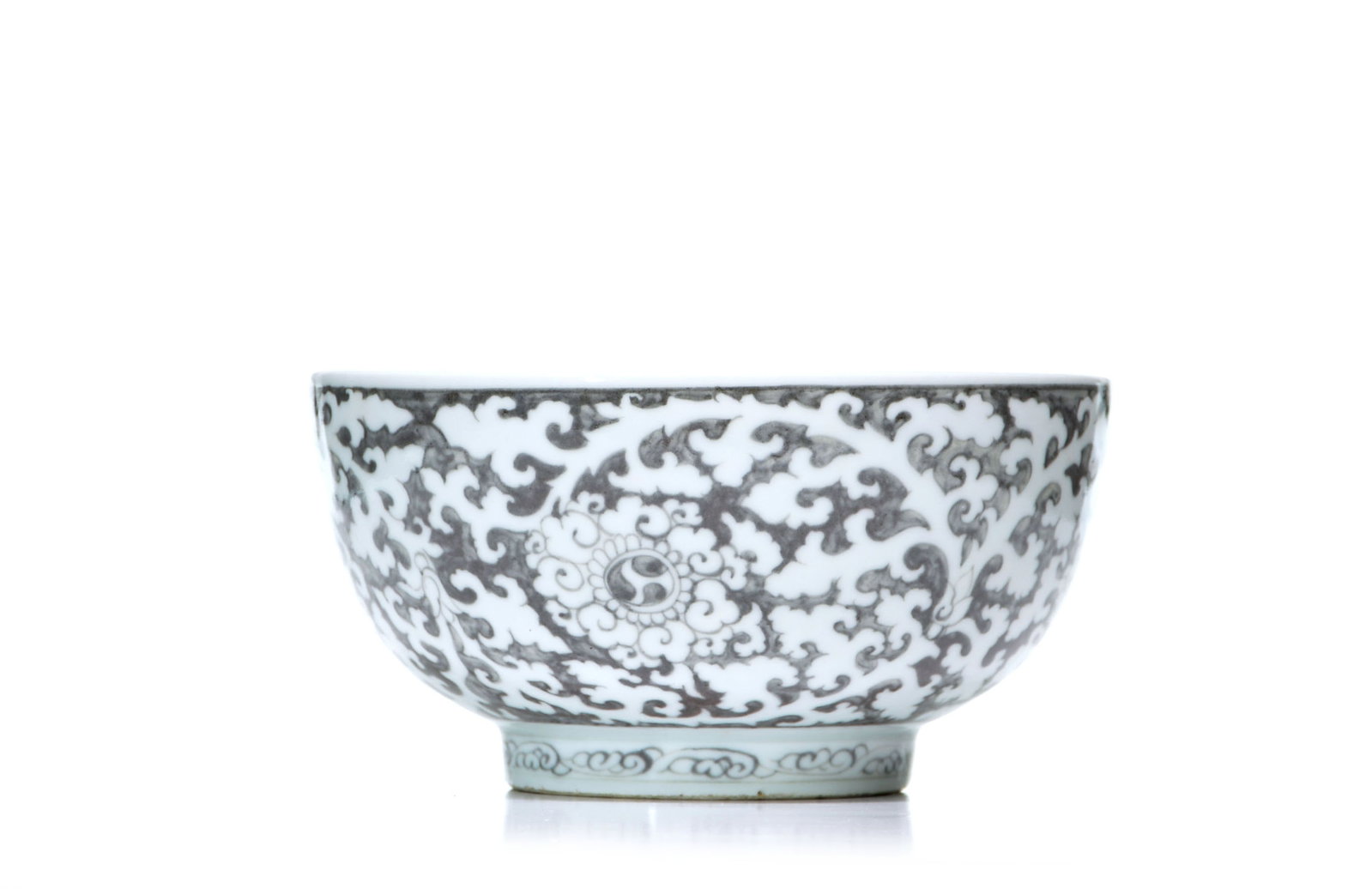 Rare Hongwu-Style Chinese Copper-Red Lotus Bowl: The rounded bowl is decorated in grisaille against a white ground with dense scrolling foliage and floral medallions enclosing stylized motifs. It is raised on a short tapered foot painted with a