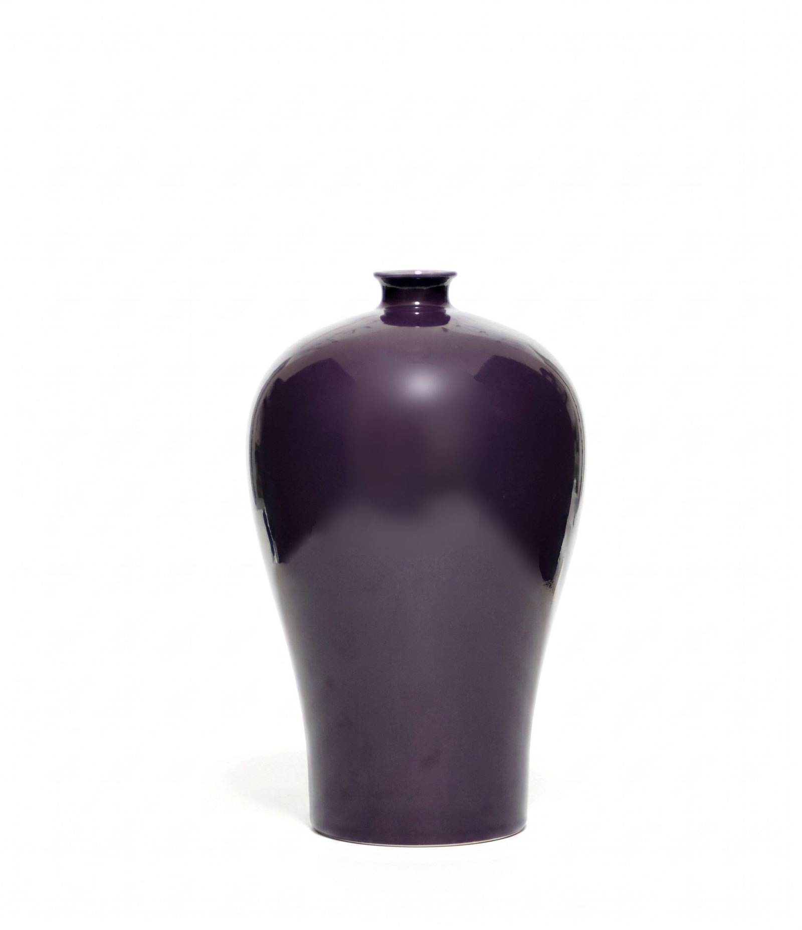Chinese Aubergine-Enameled Bottle Vase: The porcelain vase is potted with a compressed globular body rising to a short cylindrical neck and flared rim, all covered in a rich, lustrous aubergine glaze. The recessed base is left unglazed and