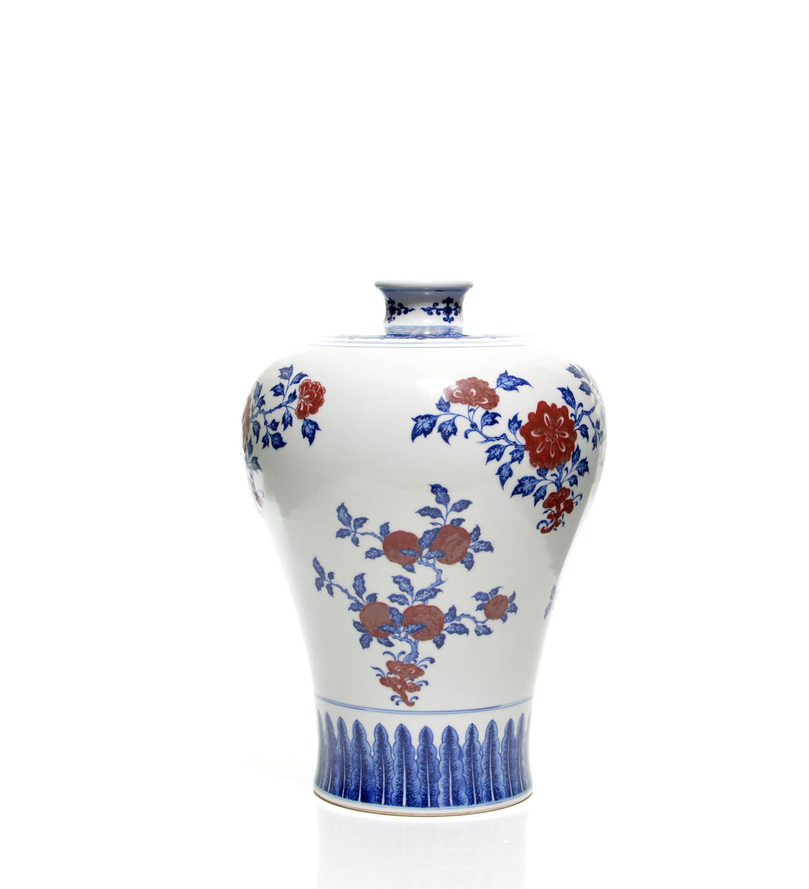 Chinese Copper-Red Decorated Blue and White Vase: The white-glazed porcelain vase is of baluster form, with a domed cover surmounted by a flared knop. It is decorated in underglaze blue and iron-red with flowering and fruiting sprays, above a band