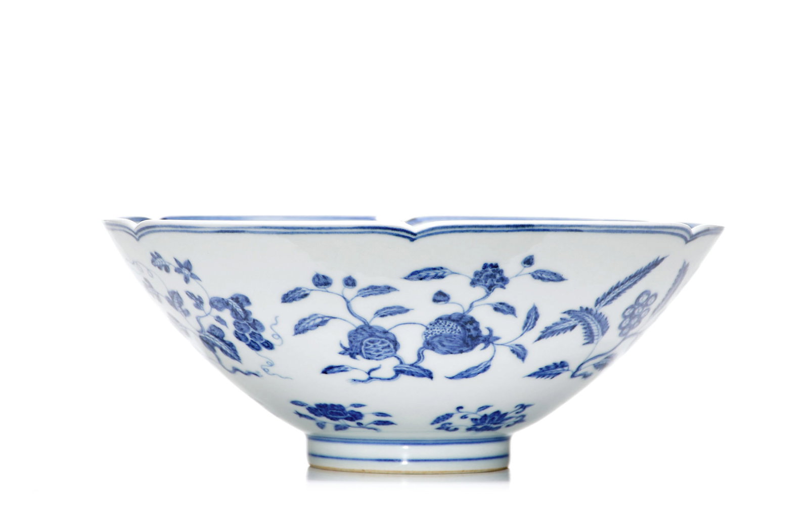 Very Fine Chinese Blue and White Floral Bowl: The bowl is potted with a flared, lobed rim and rounded sides rising from a short straight foot, all beneath a clear glaze. The exterior is painted in underglaze blue with flowering and fruiting spray