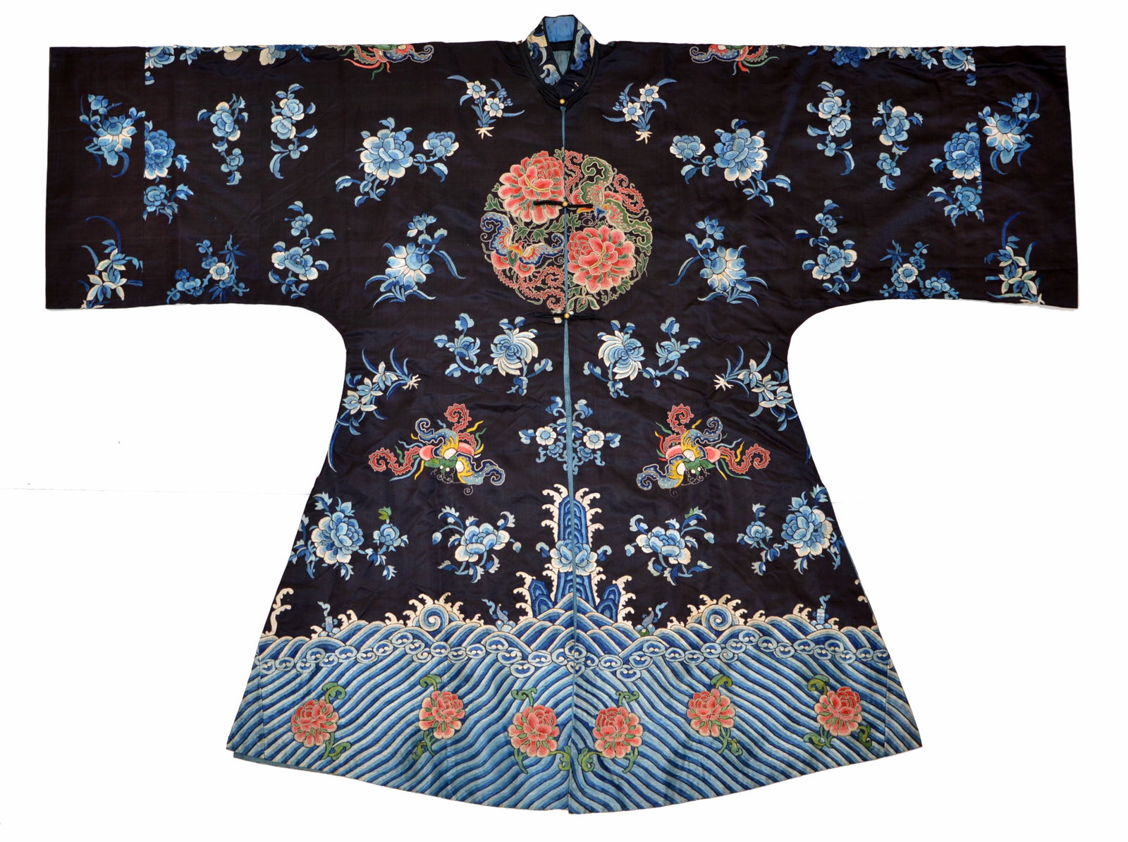 Chinese Embroidered Silk Robe: The dark-blue silk robe is cut with broad sleeves and a standing collar, fastening at the front with small metal buttons. It is embroidered with scattered blue floral sprays, butterflies among