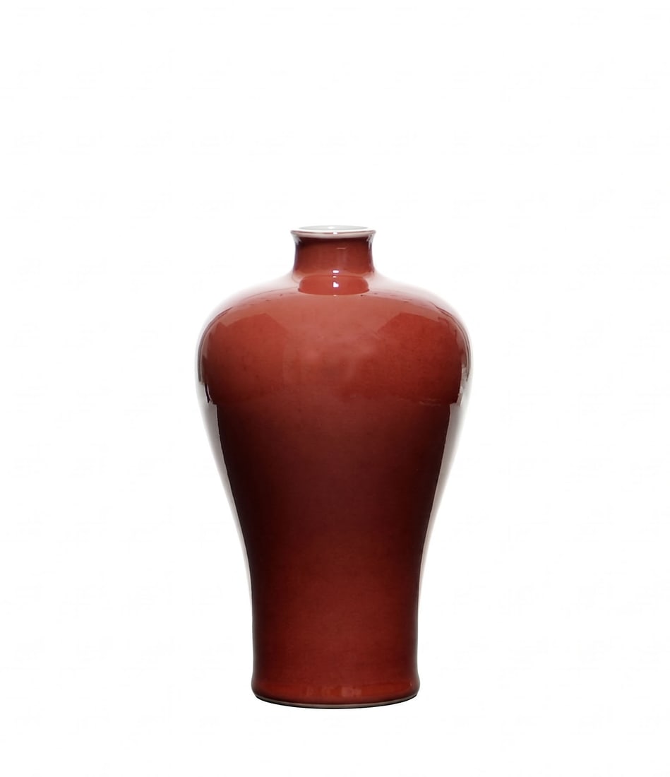 Fine Chinese Red-Glazed Bottle: The bottle is potted with a compressed globular shoulder rising to a short cylindrical neck with a slightly flared rim, above a tall tapered body. It is covered overall in a glossy deep red glaze,
