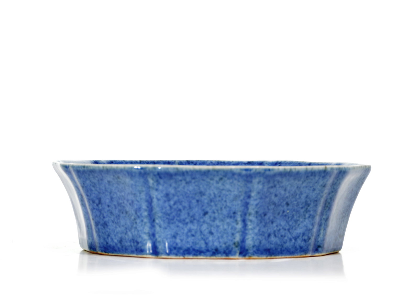 Rare Chinese Powder-Blue Lobed Bowl: The deep bowl is formed with a gently flared, lobed body and an everted rim, covered inside and out in a variegated cobalt-blue glaze with pale vertical streaking accentuating the facets. The undersid