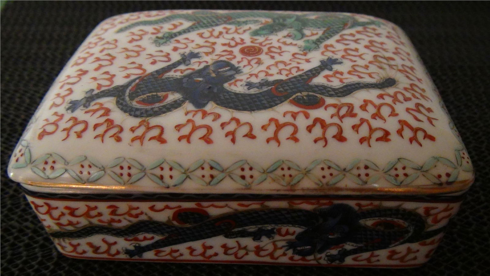 Chinese Porcelain Inkpot 1945: H: 2 in/5cm W: 4.5 in/11 cm D: 3.5 in/9 cm Hand painted double dragons in green and blue colors. Made in Hong Kong. Time: Occupied Hong Kong: around 1945.