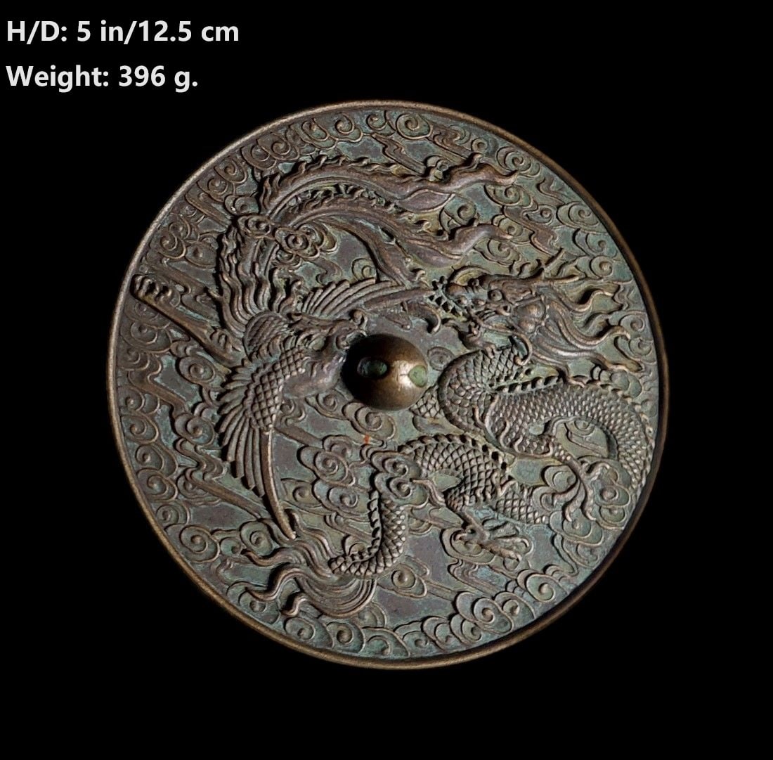 CHINESE ANTIQUE DRAGON AND PHOENIX BRONZE MIRROR L: THIS ITEM H: 5 in/12.5 cm D: 5 in/12.5 cm Weight: 396 g. FEATURES 1. Hand carved dragon, phoenix, and luck clouds. 2. The meaning of the images: Long Feng Chen Xiang (The dragon and phoenix present go