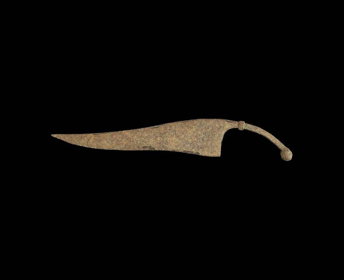 Iron Age Single-Edged Knife: 3rd century BC-1st century AD. An iron single-edged knife or cleaver with scooped edge, curved handle with applied collar and ball finial. For similar see Portable Antiquities Scheme ref. WMID-A2FE55.