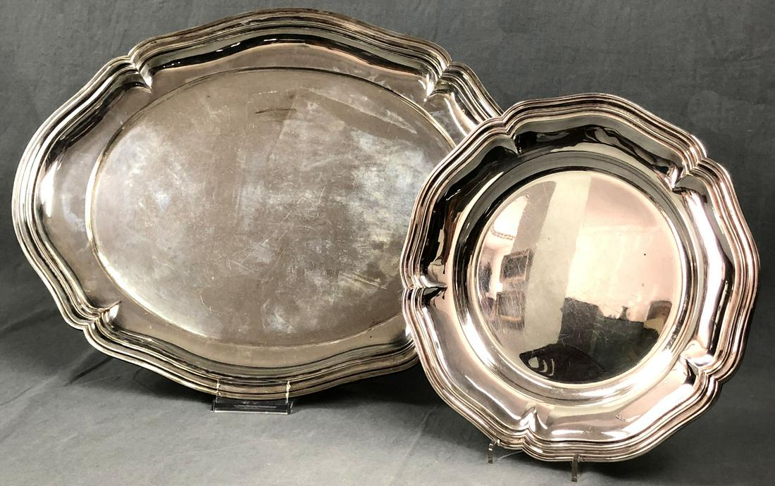 Large serving plate silver 835 and a plate silver 830.: 1738 grams. Up to 48.5 cm x 37.5 cm. Hallmarks. German Description: Große Servierplatte Silber 835 und ein Teller Silber 830. 1738 Gramm. Bis 48,5 cm x 37,5 cm. Marken.