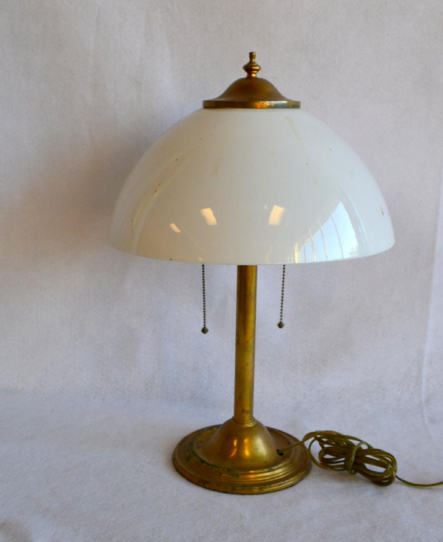 Brass clad table lamp with original opaque white glass: Brass clad table lamp with original opaque white glass shade, circa 1900 – 21"H x 13.75"D. Slight ding to neck of lamp, else very good condition.
