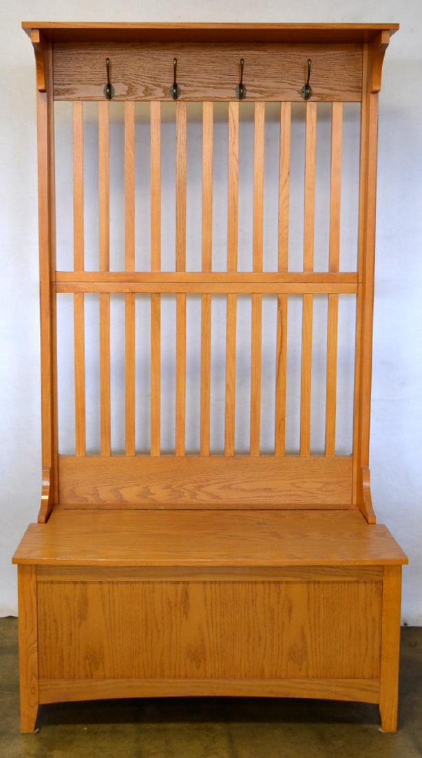 Modern oak hall seat having a coat rack over slat back: Modern oak hall seat having a coat rack over slat back over lift-top seat. This is a new oak piece from a local estate with only slight use wear and in very good overall condition. 70"H x 38"W x 19"D.