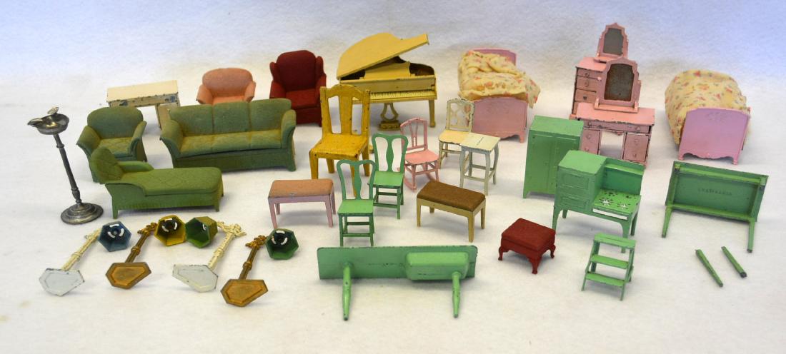 Large grouping of metal dollhouse furniture, most: Large grouping of metal dollhouse furniture, most Tootsie Toy, including matching couches and chairs, bedroom set, 4 floor lamps, piano, kitchen stove and sink. Piano with broken leg, kitchen table wi