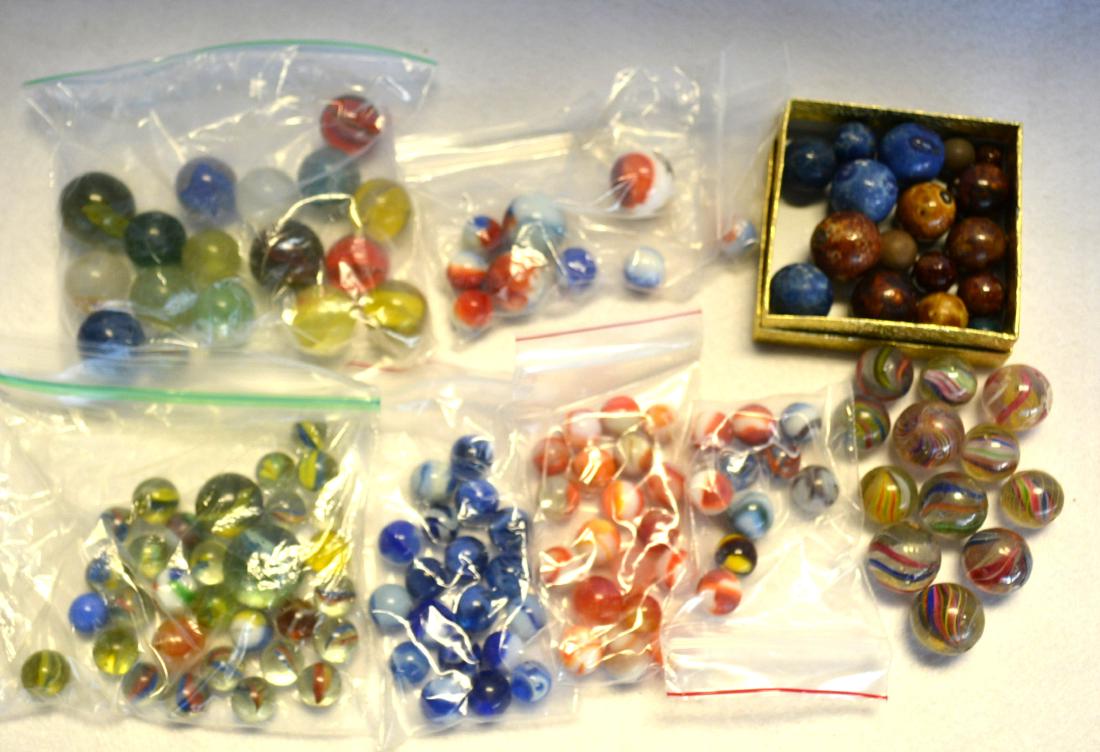 Grouping of approximately 100 various vintage marbles: Grouping of approximately 100 various vintage marbles including Bennington glaze marbles, glass solid core swirl marbles, cats eye marbles, etc. Size range from .5" to 1"D. Most of the older swirl mar