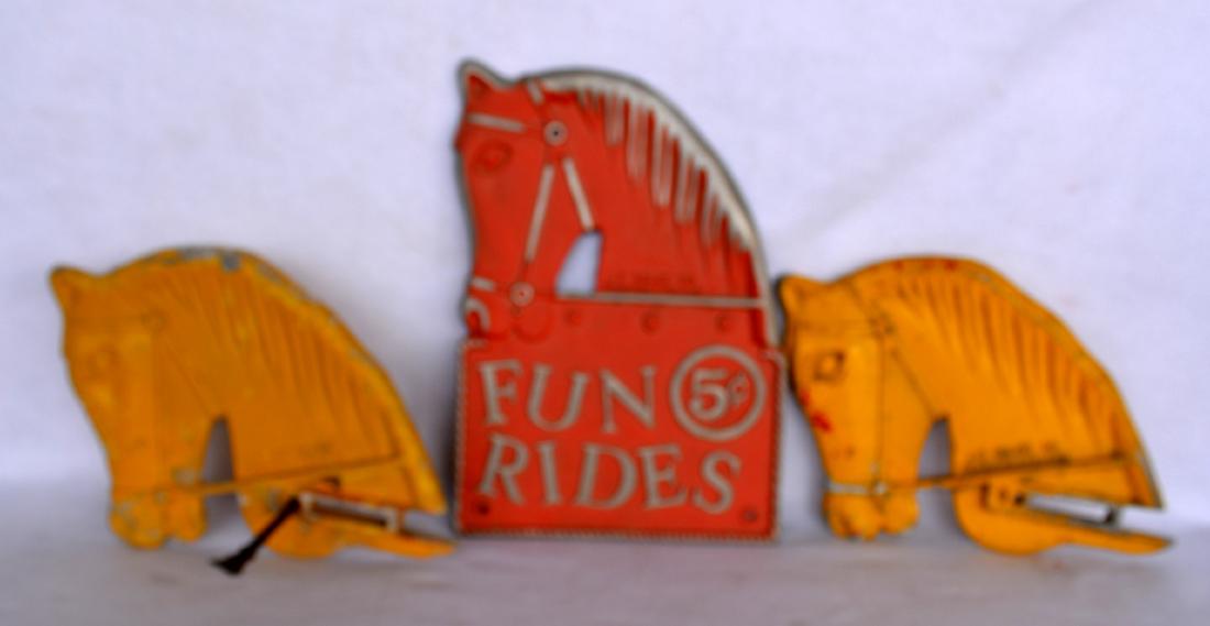 Three colorful cast aluminum playground toy horse: Three colorful cast aluminum playground toy horse heads signed J.E. Burk Co. Fond Du Lac Wis. Two 15" heads and one single sided reading "Fun Rides 5 cents". Some paint loss, but overall good conditio