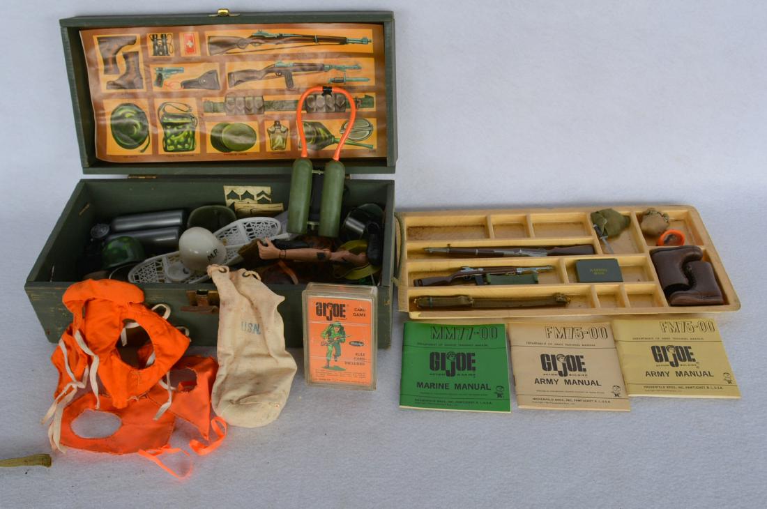 G.I. Joe footlocker with large amount of mostly G.I.: G.I. Joe footlocker with large amount of mostly G.I. Joe accessories including helmets, shoes, boot, rifles, canteens, ammo box, card game - 1964 Whitman Publishing, 3 Army & Marine training manuals c