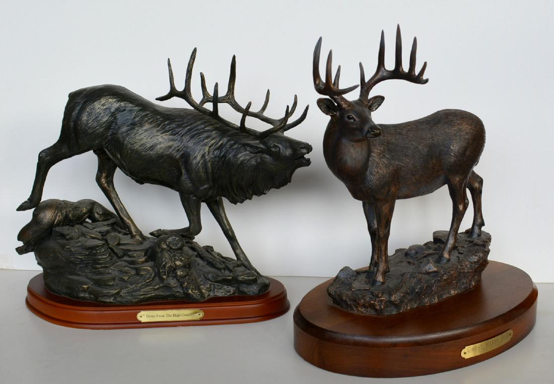 Two modern faux bronze standing stags including:: Two modern faux bronze standing stags including: White-tail entitled "Ghost Marsh Buck' by Ducks Unlimited and signed on base BJ Williams #2626 - 12"L x 12.5"H, and a bull elk "Down From The High Coun