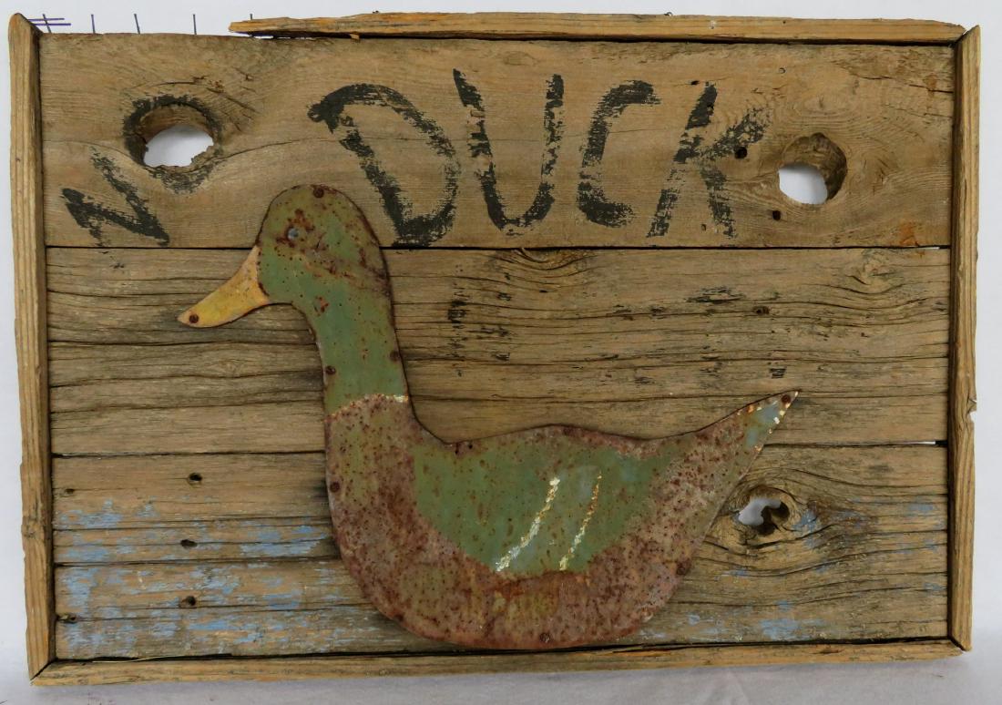 Old wooden sign marked “NO DUCK HUNTING” with an (1 of 2)