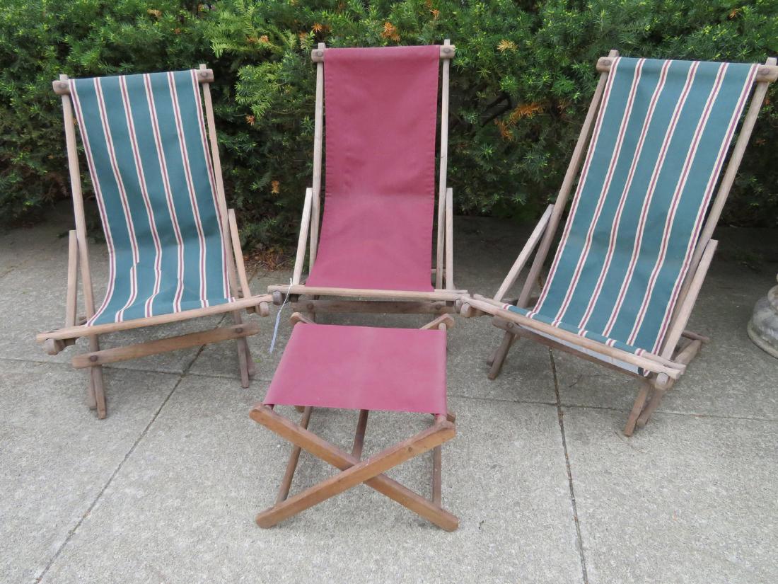 Three folding deck chairs with canvas seats together