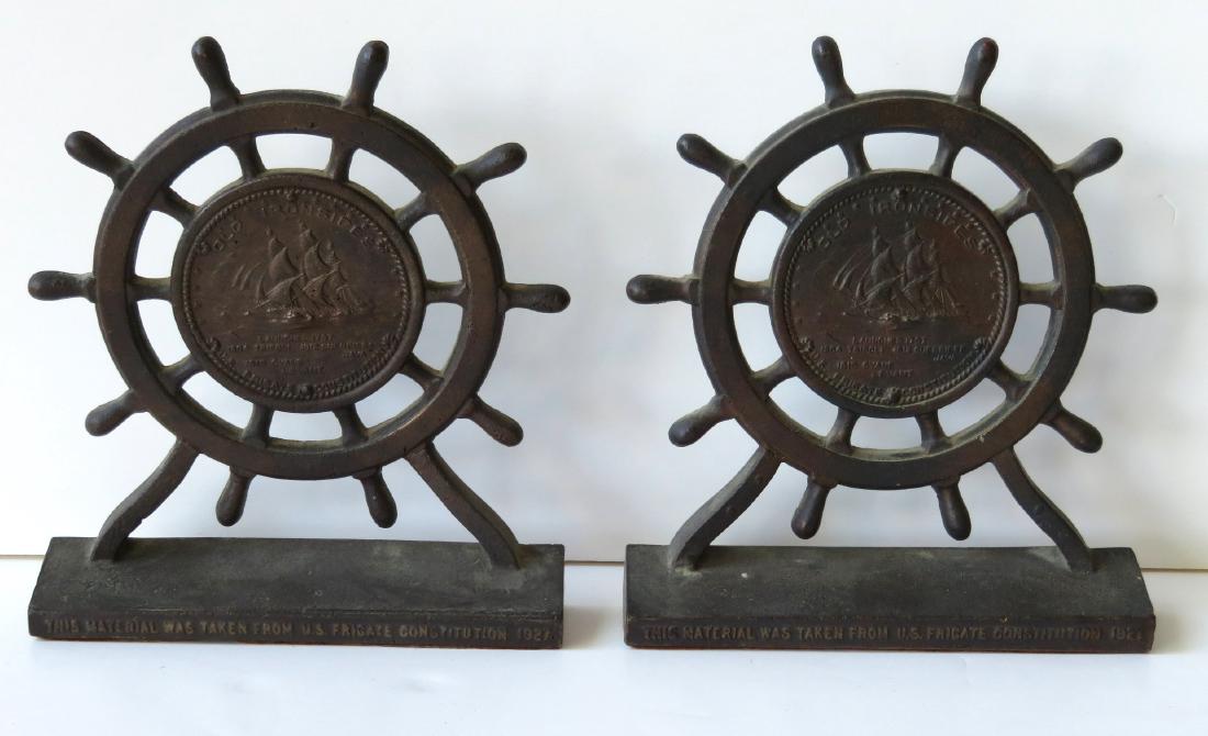 Pair of brass bookends with bronze finish, marked "Old: Pair of brass bookends with bronze finish, marked "Old Ironsides" in the form of ship wheels - the base is marked "This Material Was Taken From The US Frigate Constitution, 1927" (these bookends were