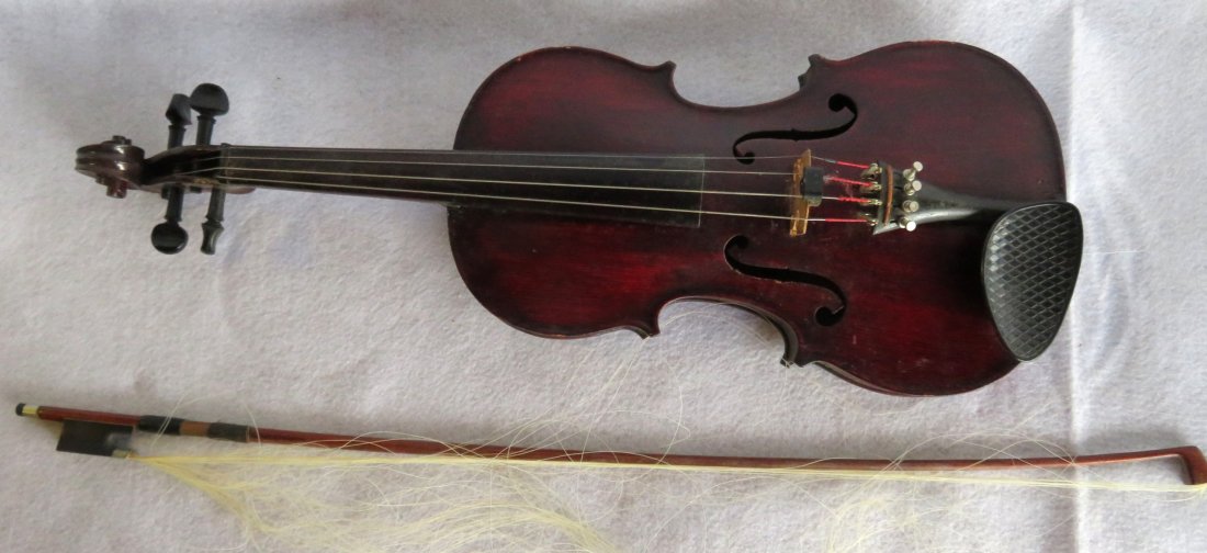 Violin with paper label signed Medio Fino – smaller: Violin with paper label signed Medio Fino – smaller paper label initialed J.T.L - bow signed R. Paesold. Violin, in original box, is covered with an old varnish, otherwise good structural condition.