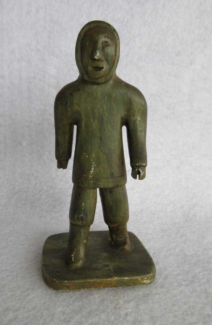 Soapstone Inuit figure of a walking man signed Tatigat: Soapstone Inuit figure of a walking man signed Tatigat E-5-553 - (SIMEONIE TATIGAT SIAKULUK, Canadian born in 1959). 5.5"H. Good condition.