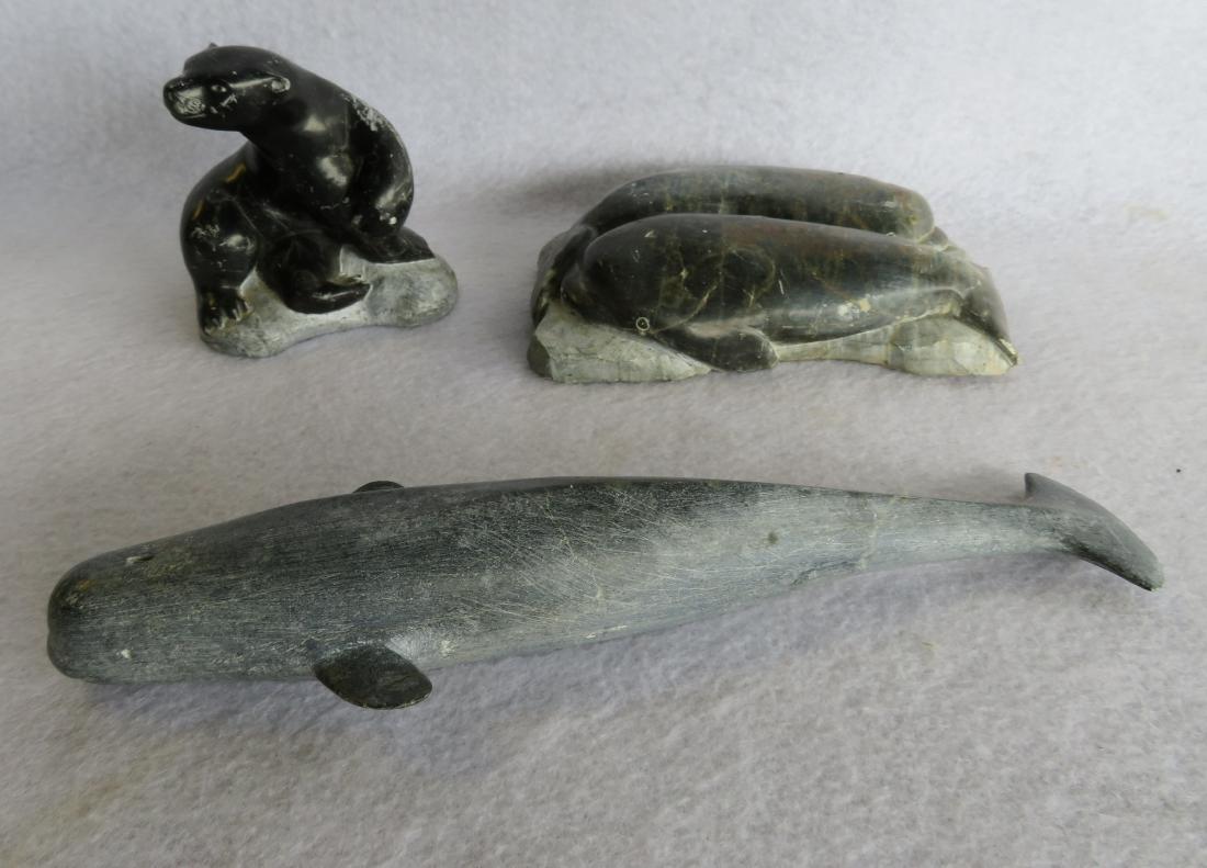Three Inuit stone carvings including 2 resting seals on: Three Inuit stone carvings including 2 resting seals on ice - signed illegibly and numbered 1-61384 - 6.25"L - several surface scratches but overall good condition; a whale - 9.75"L - very good condit
