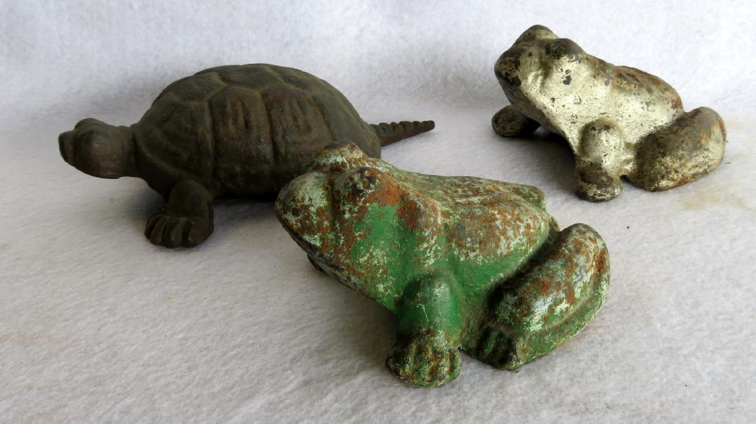 Three cast iron door stops including 2 bull frogs - 5"L: Three cast iron door stops including 2 bull frogs - 5"L and a turtle - 7.75"L - some paint loss but overall good condition. Circa 1900.