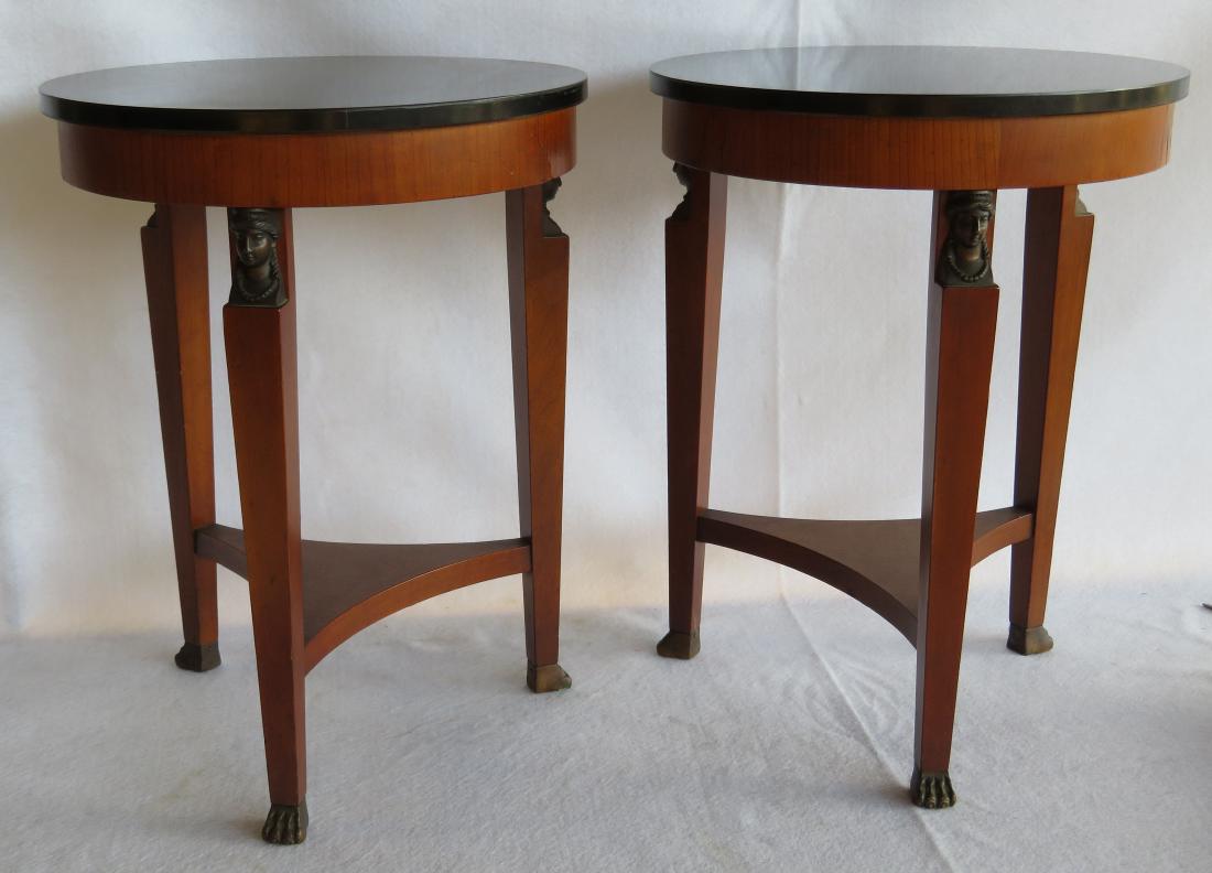 Two small Biedermeier style end tables having an: Two small Biedermeier style end tables having an enameled black top over tripod legs, each with an applied faux bronze figure of a lady under the top apron, also having a connecting lower shelf and br