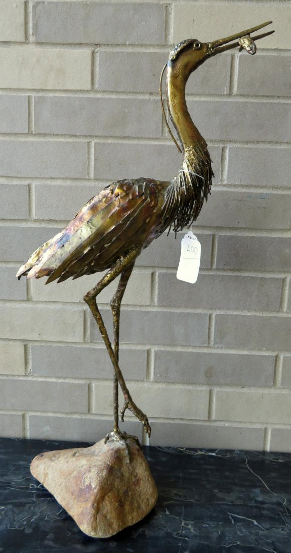 Cast iron and tin sculpture of a crane standing on rock: Cast iron and tin sculpture of a crane standing on rock with fish in mouth - faux bronze finish - very good condition - 26"H. Provenance: From the estate of Ron & Elizabeth Boedecker, Poughkeepsie NY.