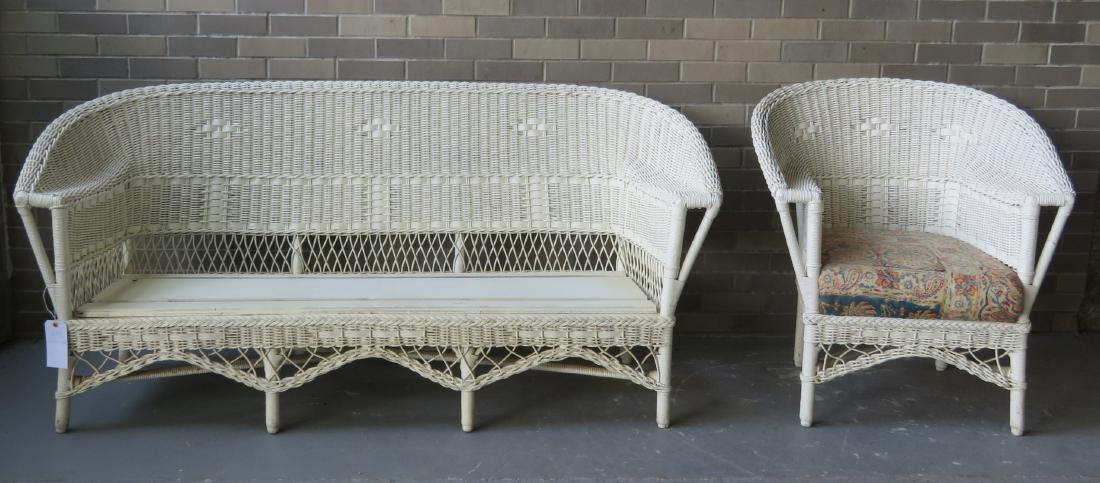 Vintage wicker sofa and matching chair with resting: Vintage wicker sofa and matching chair with resting arms, circa 1920. Sofa missing cushion, otherwise very good condition. The sofa 69.5”W x 33”H x 26”D – the side chair 29.5”W x 34”H x 26